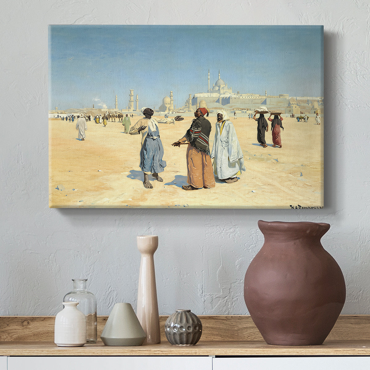 Canvas art print featuring a scene of figures crossing sandy terrain with distant skyline, styled above a decorative console