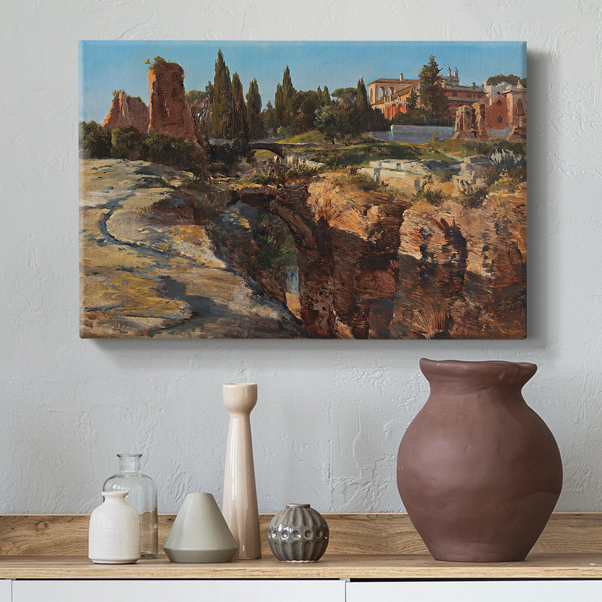 Canvas art print featuring a cityscape with classical ruins and surrounding terrain, styled above a decorative console