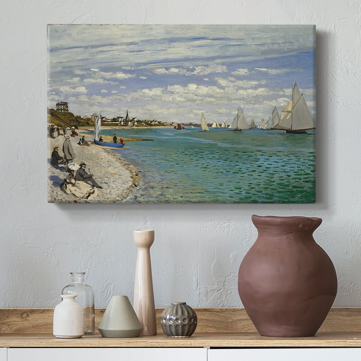 Canvas art print featuring an impressionist coastal view with colorful sails and shoreline activity, styled above a decorative console