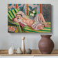 Canvas art print featuring an expressive reclining figure amid floral motifs, styled above a decorative console