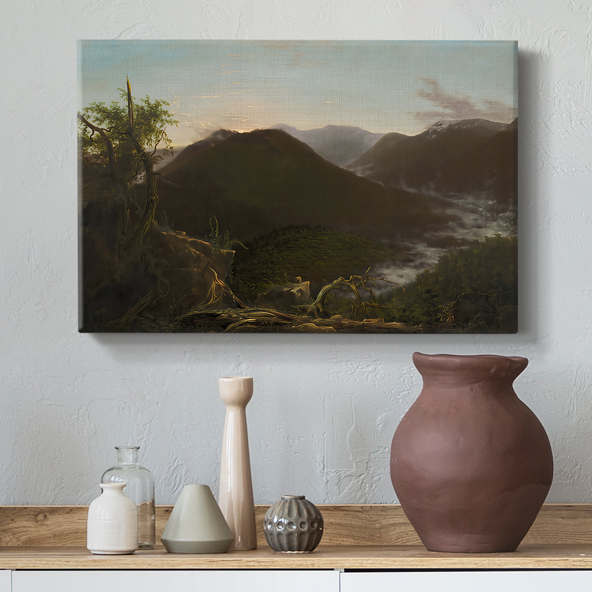 Canvas art print featuring a scenic sunrise view with deep valley and layered peaks, styled above a decorative console