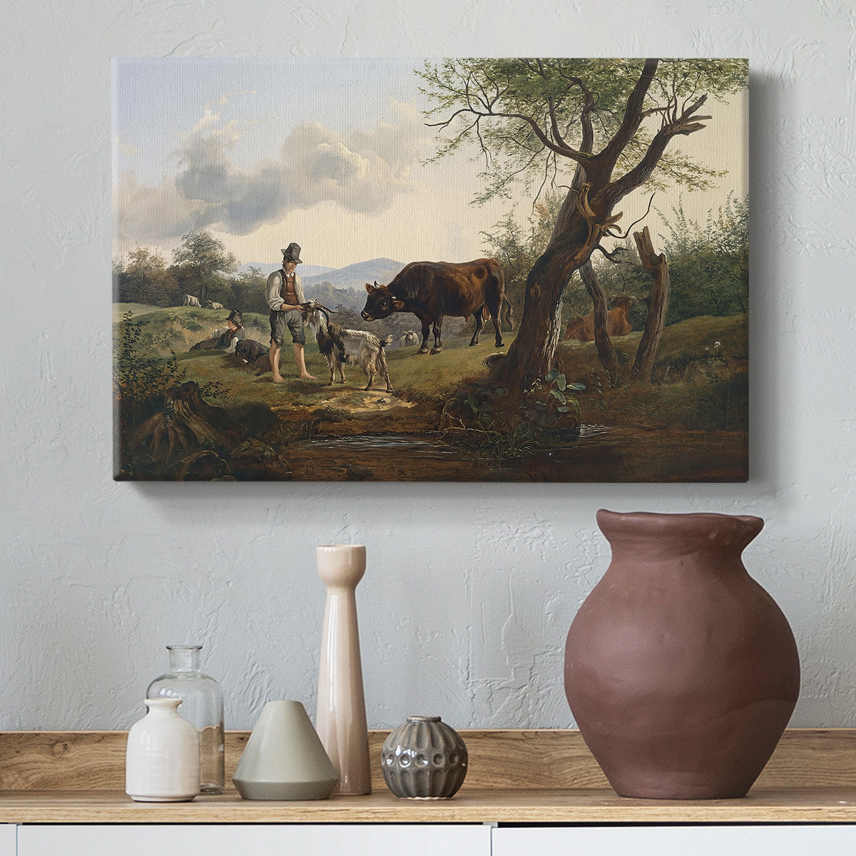 Canvas art print featuring a pastoral interaction between human and livestock, styled above a decorative console