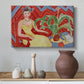 Canvas art print featuring a stylized seated female figure in strong warm tones, styled above a decorative console