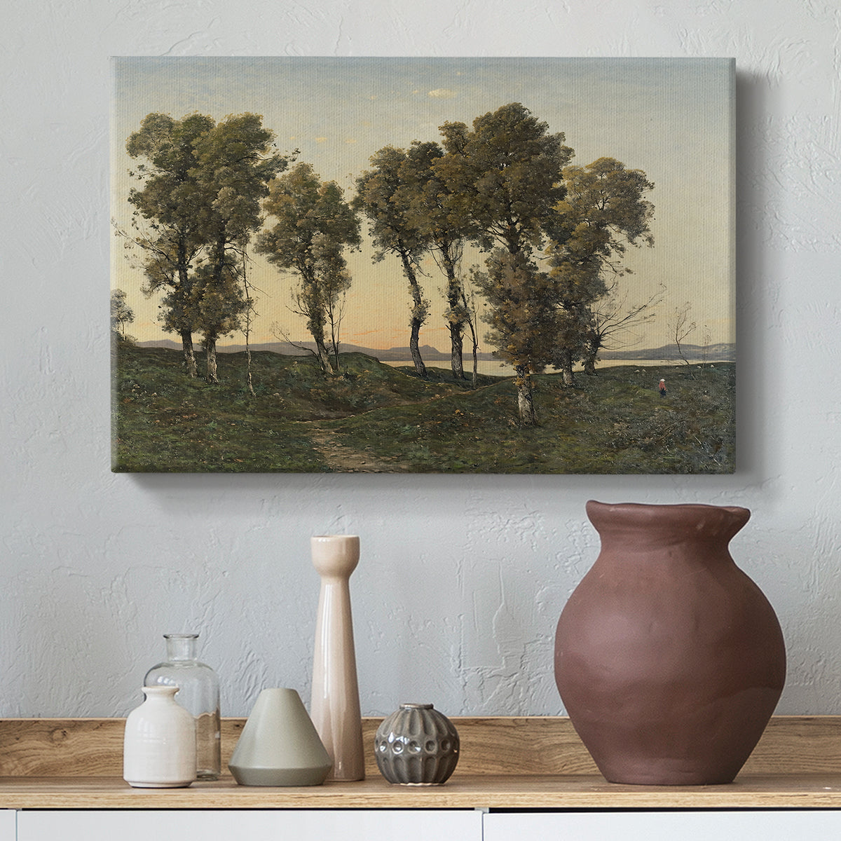 Canvas art print featuring a countryside scene at dusk with trees and soft horizon, styled above a decorative console