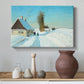 Canvas art print featuring a winter day with fresh snow and figure working outdoors, styled above a decorative console