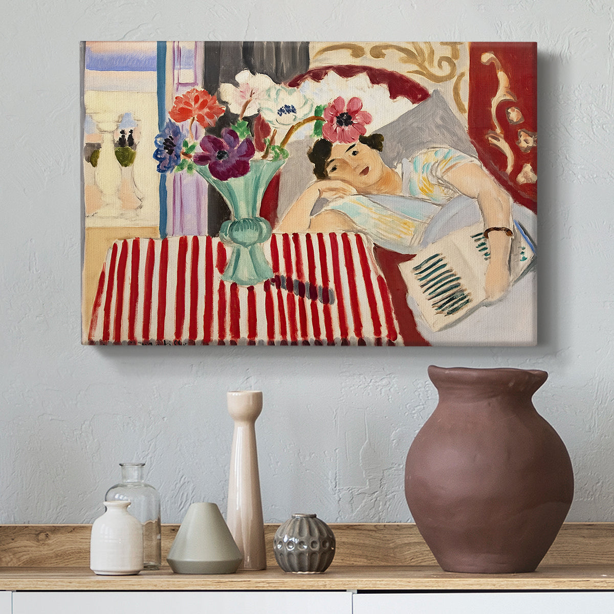 Canvas art print featuring an expressive interior with woman and bright flowers on table, styled above a decorative console