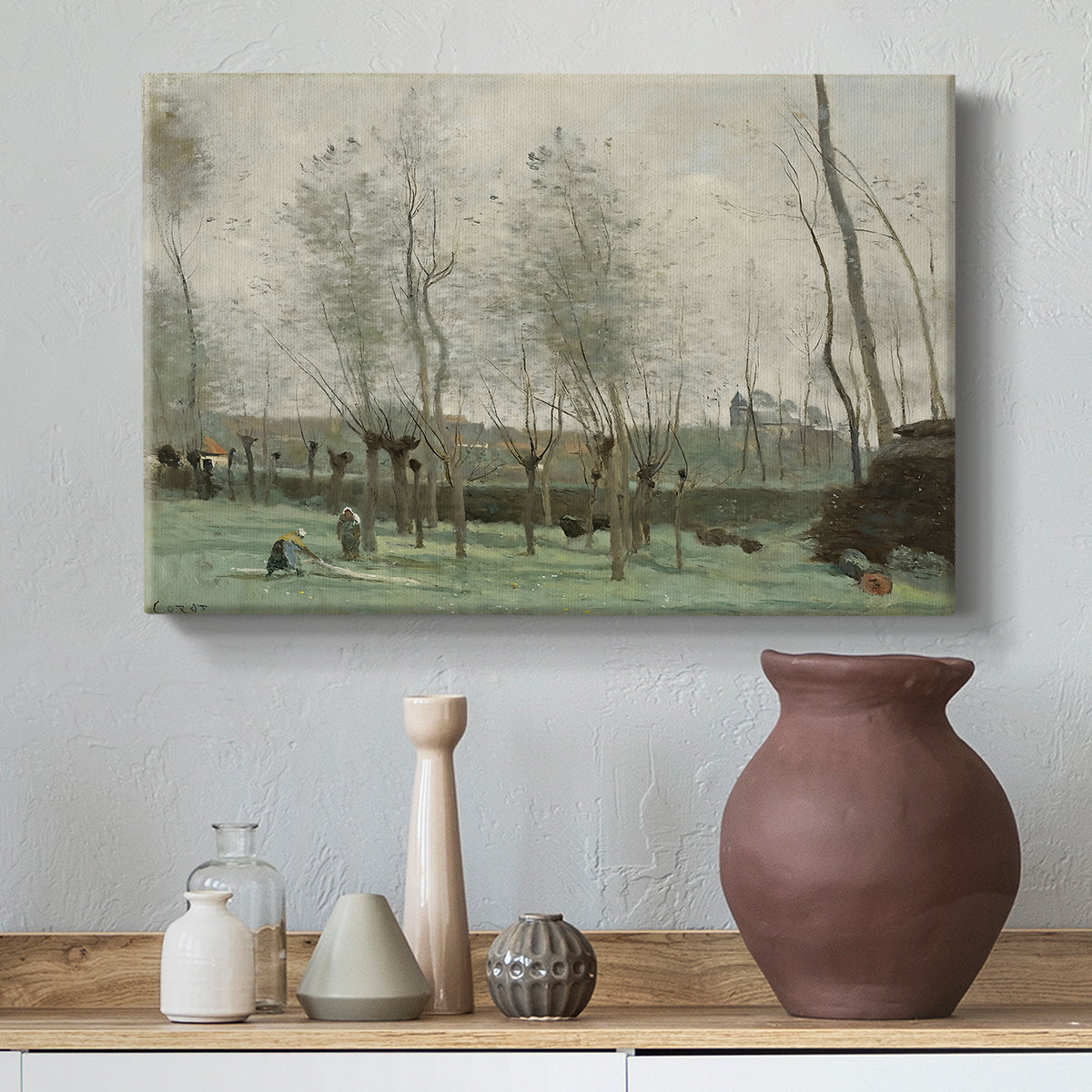 Canvas art print featuring a soft landscape with people and trees in calm setting, styled above a decorative console
