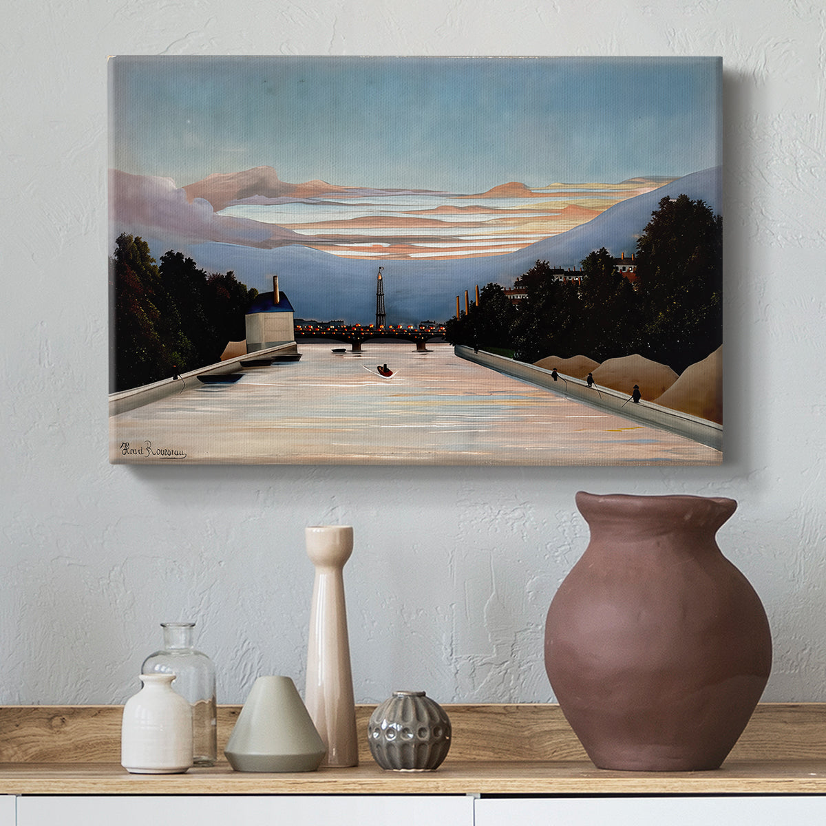 Canvas art print featuring a naïve cityscape with tower and surrounding greenery, styled above a decorative console