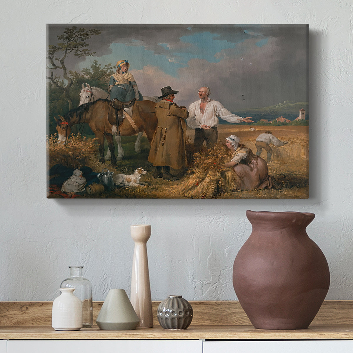 Canvas art print featuring countryside activity with figures engaged in harvest, styled above a decorative console