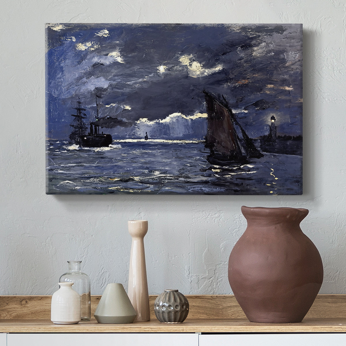 Canvas art print featuring a dramatic ocean scene with light reflecting across water at night, styled above a decorative console