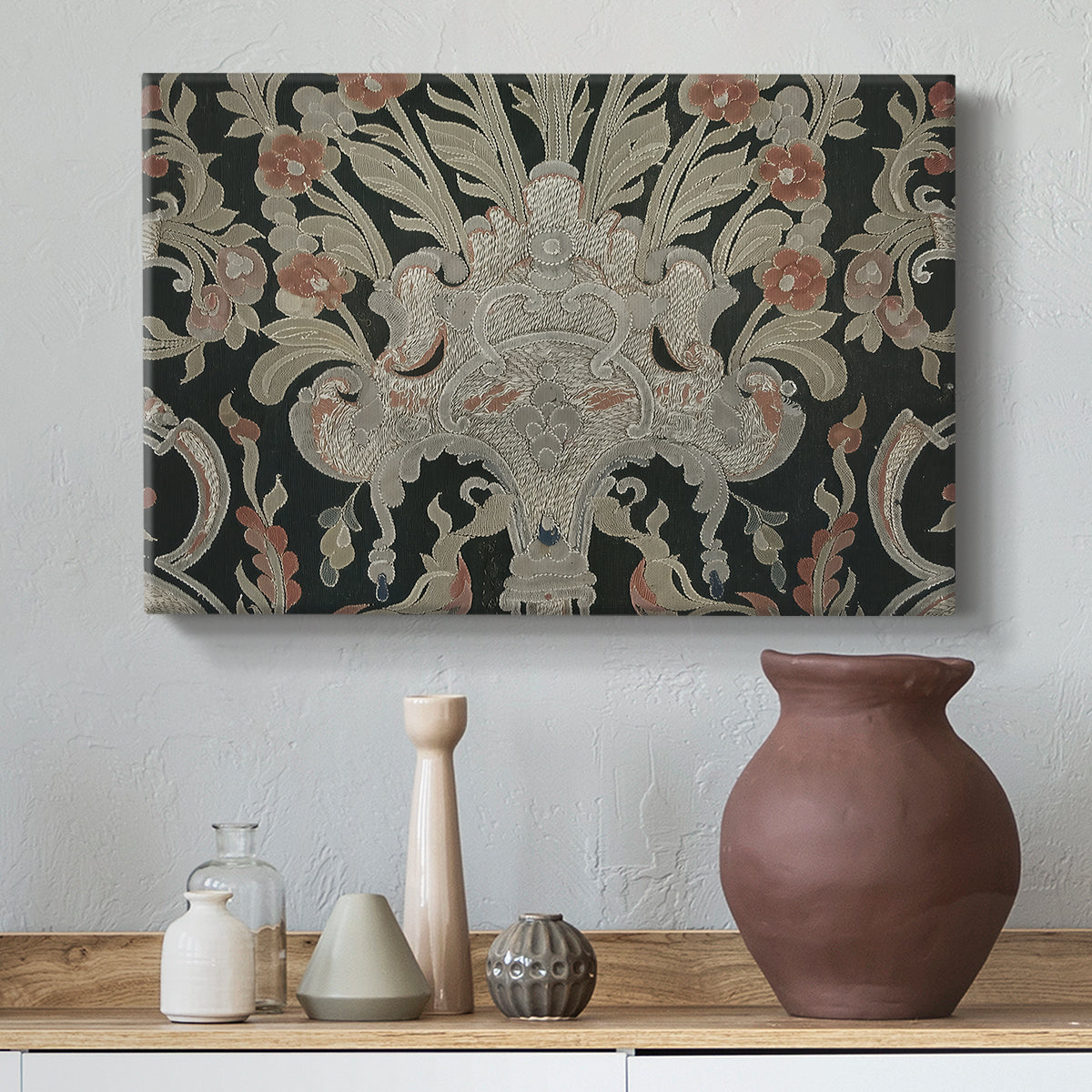 Canvas art print featuring an ornamental composition with layered motifs and repeating figures, styled above a decorative console