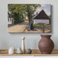 Canvas art print featuring a countryside scene with figures exchanging goods outdoors, styled above a decorative console