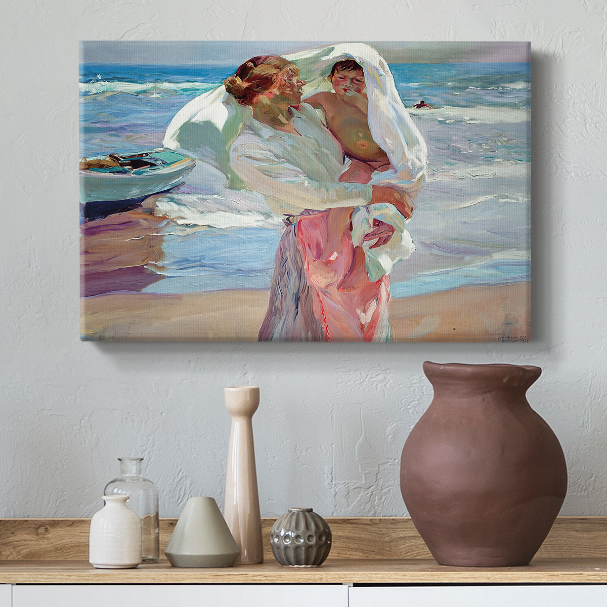 Canvas art print featuring a bright coastal composition with figures and shoreline, styled above a decorative console