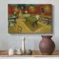 Canvas art print featuring a post-impressionist café setting with vivid color contrast and empty tables, styled above a decorative console