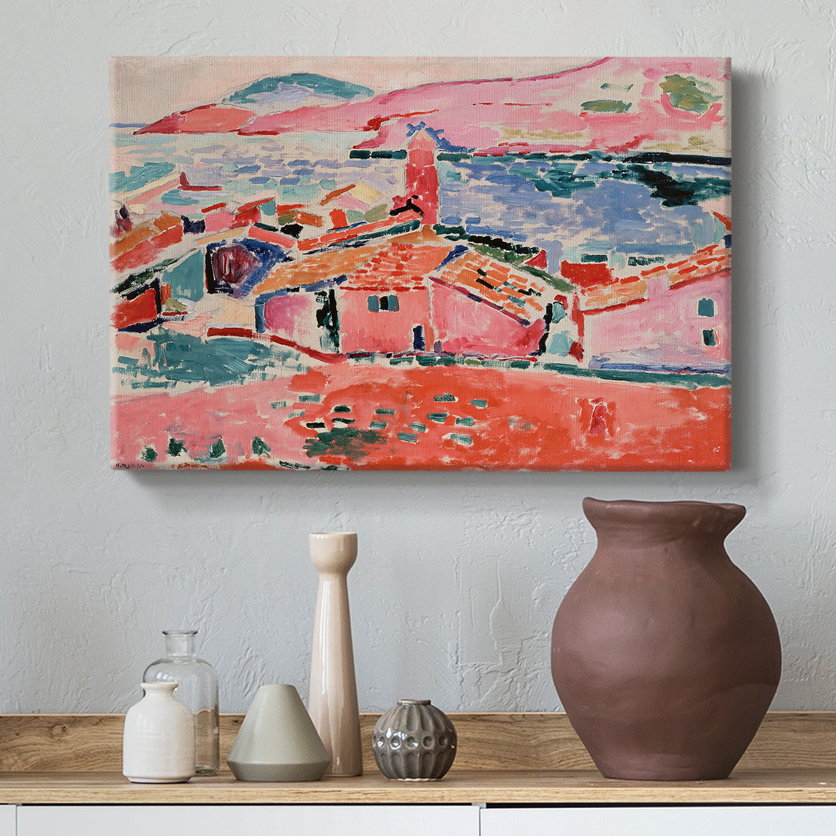 Canvas art print featuring a Fauvist cityscape of a seaside town in vivid tones, styled above a decorative console