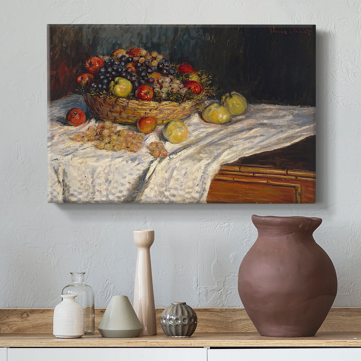 Canvas art print featuring a close-up of apples and grapes in warm tones, styled above a decorative console