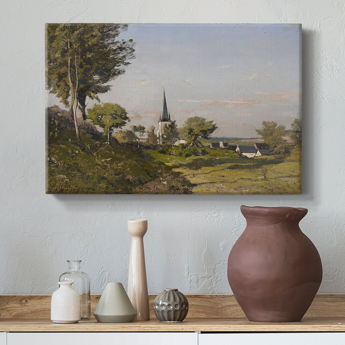Canvas art print featuring a peaceful village landscape with architecture and nature, styled above a decorative console
