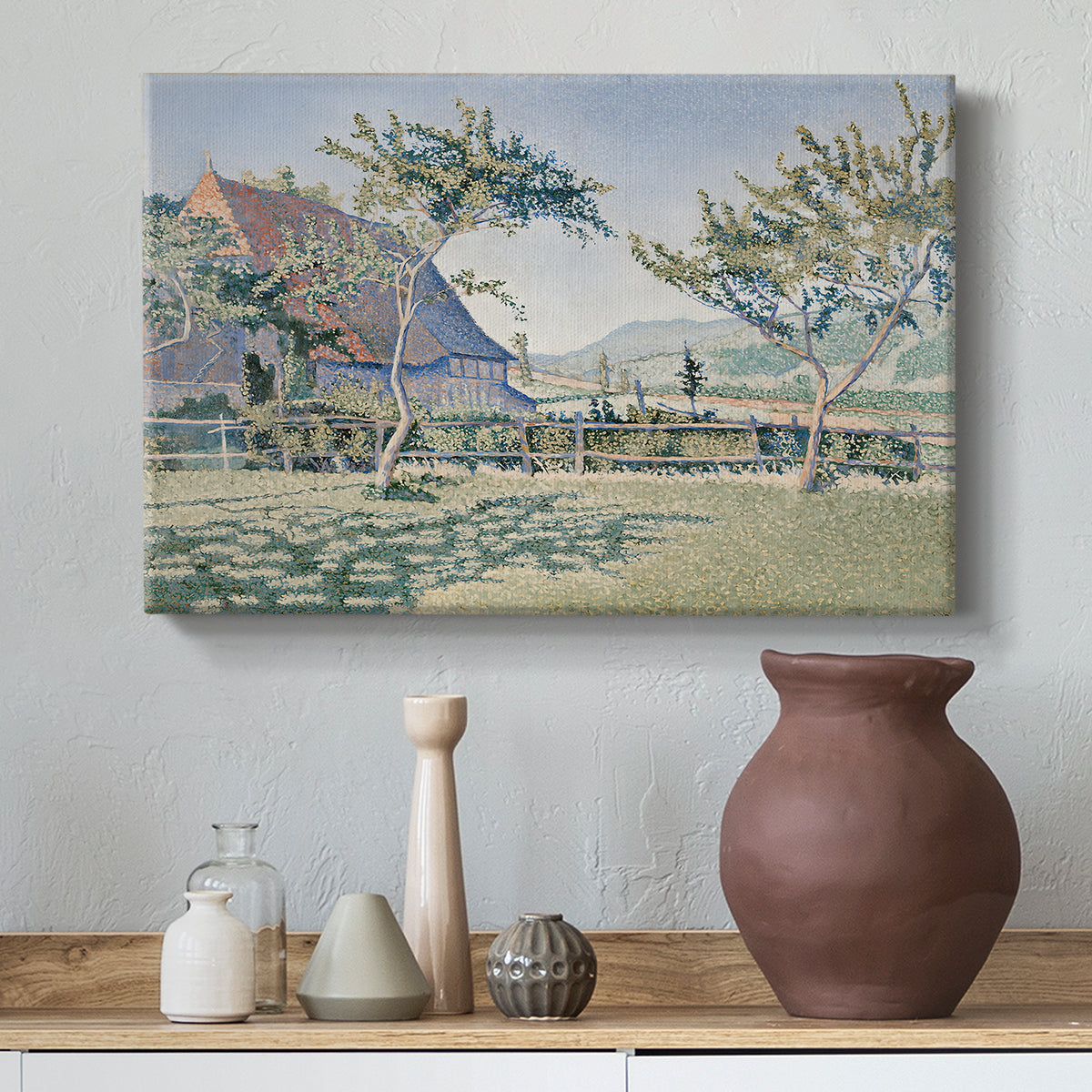 Canvas art print featuring a rural composition with houses and greenery, styled above a decorative console