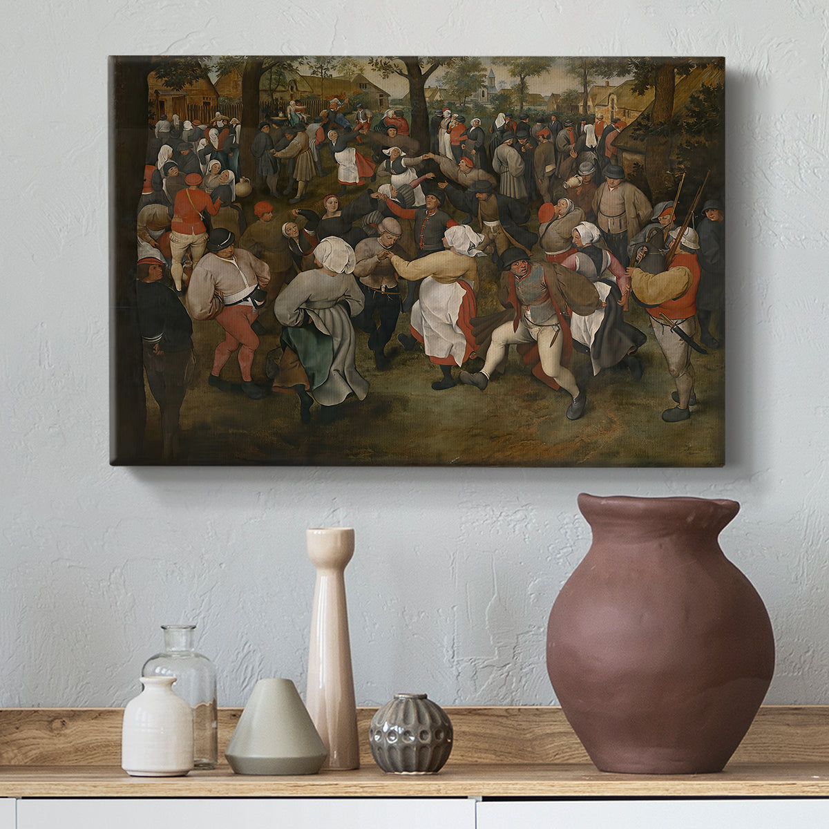 Canvas art print featuring an expressive depiction of communal celebration in village setting, styled above a decorative console