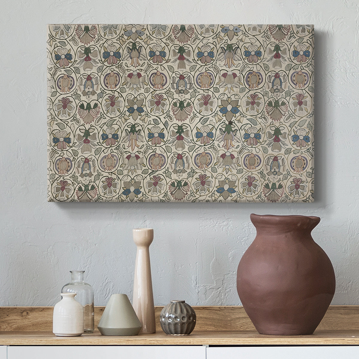 Canvas art print featuring a patterned textile featuring repeated flowers and leaves, styled above a decorative console