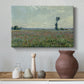 Canvas art print featuring a rural meadow with scattered poppies and soft horizon, styled above a decorative console