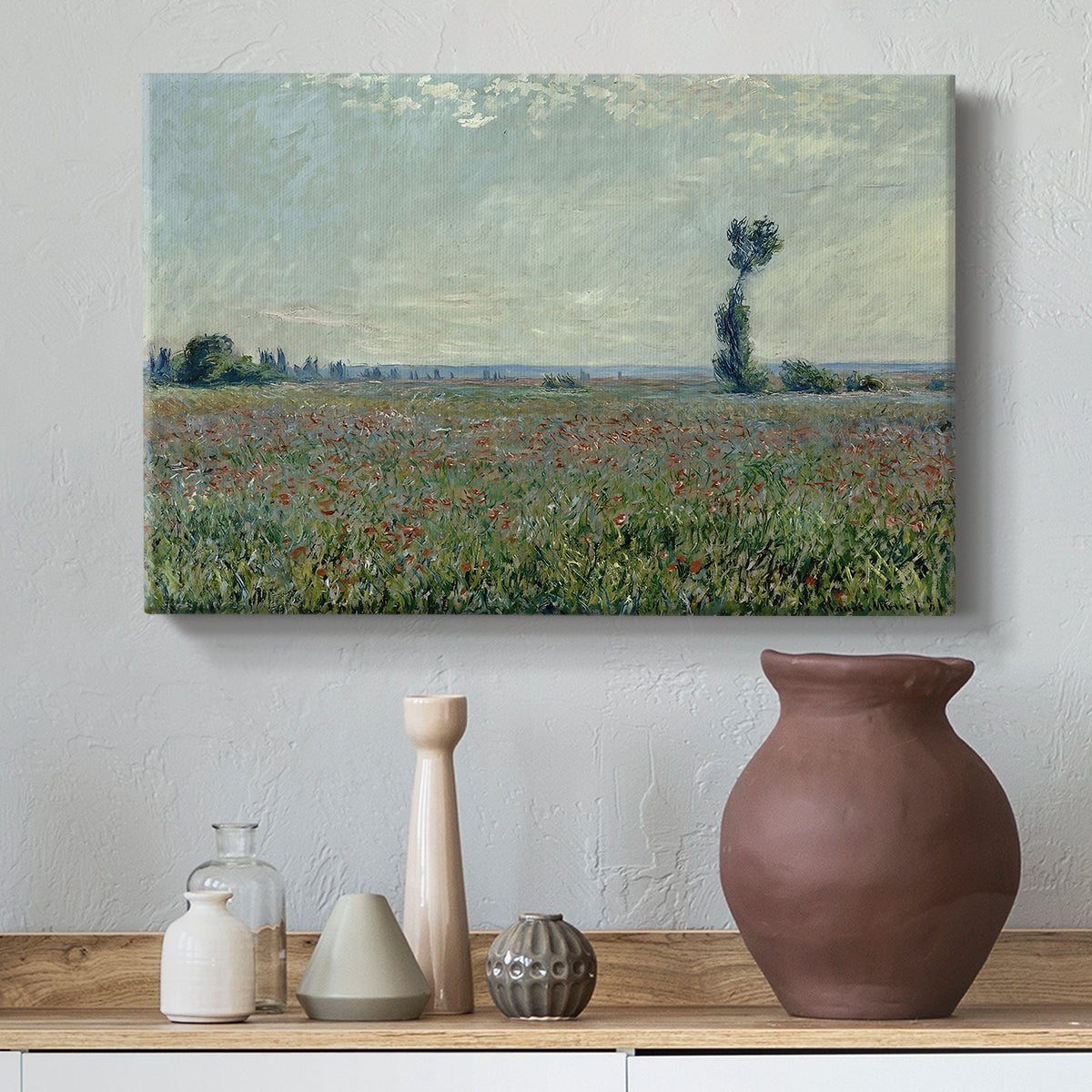 Canvas art print featuring a rural meadow with scattered poppies and soft horizon, styled above a decorative console