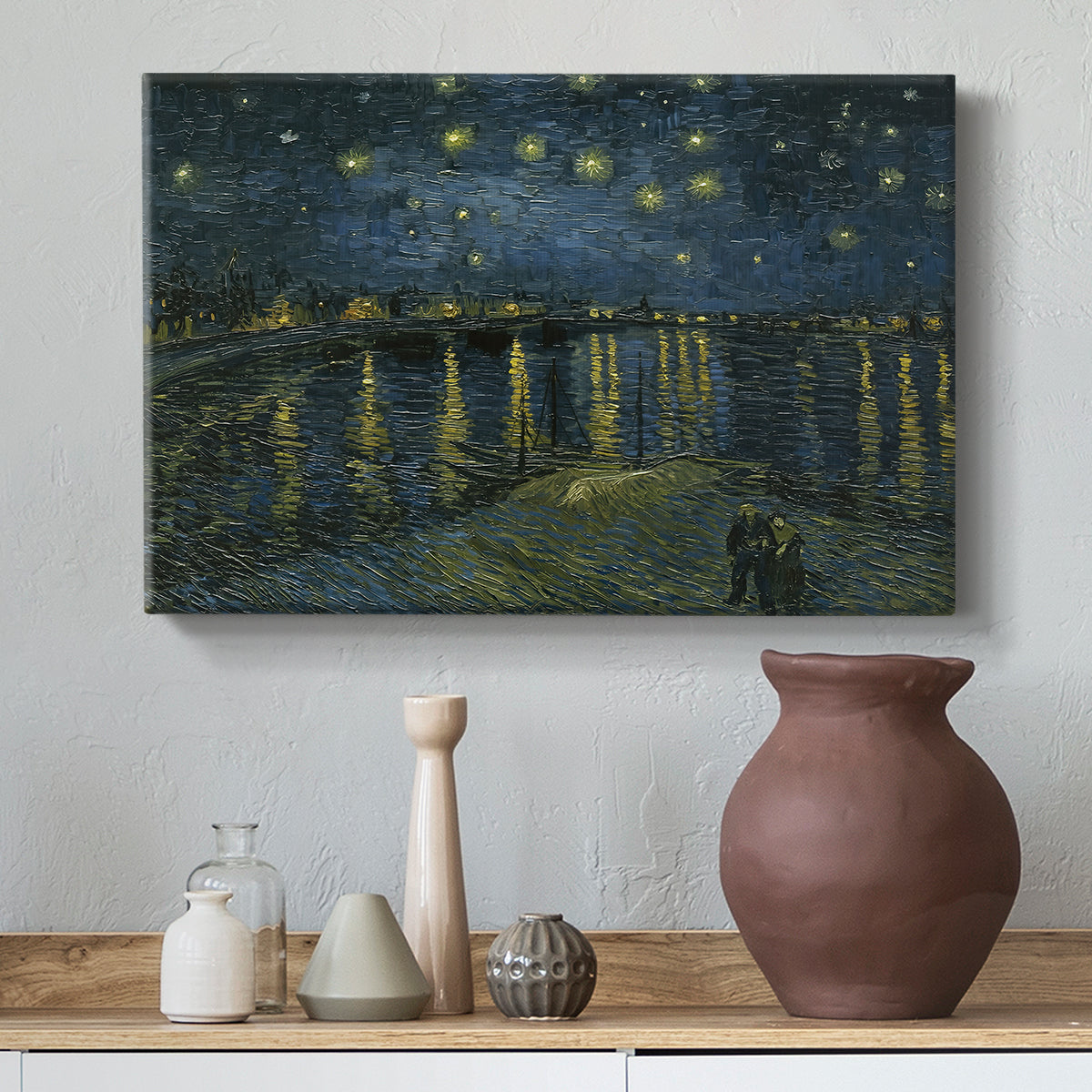 Canvas art print featuring a riverside view with figures near water under star-filled sky, styled above a decorative console