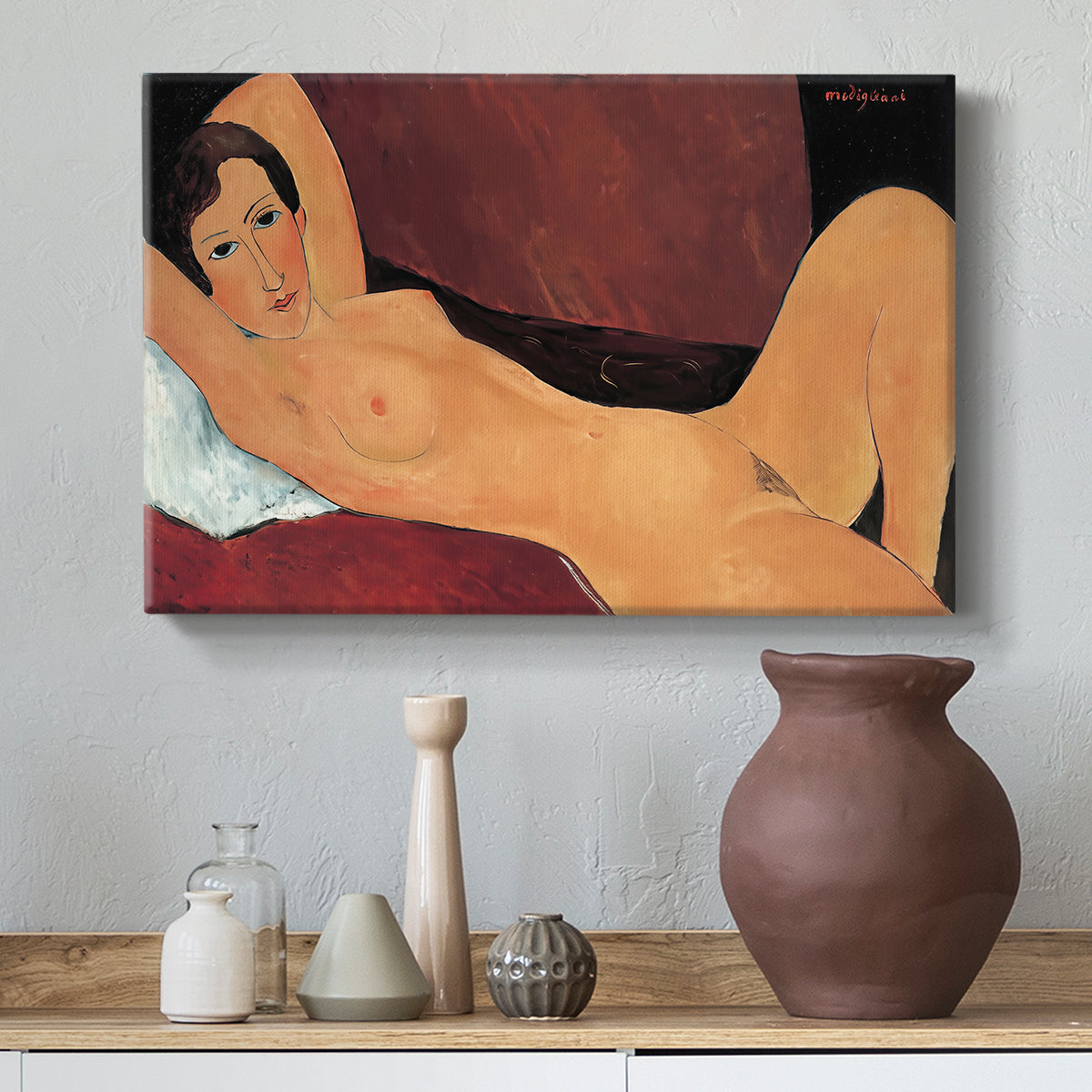 Canvas art print featuring a stylized female nude with elongated proportions resting on couch, styled above a decorative console
