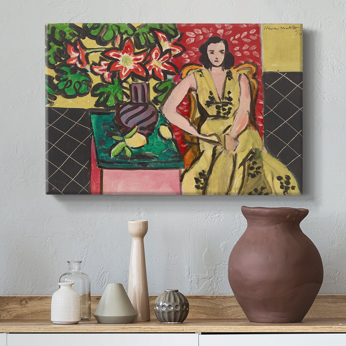 Canvas art print featuring a colorful interior with a seated woman and blooming flowers, styled above a decorative console