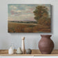 Canvas art print featuring a countryside scene with distant town, styled above a decorative console