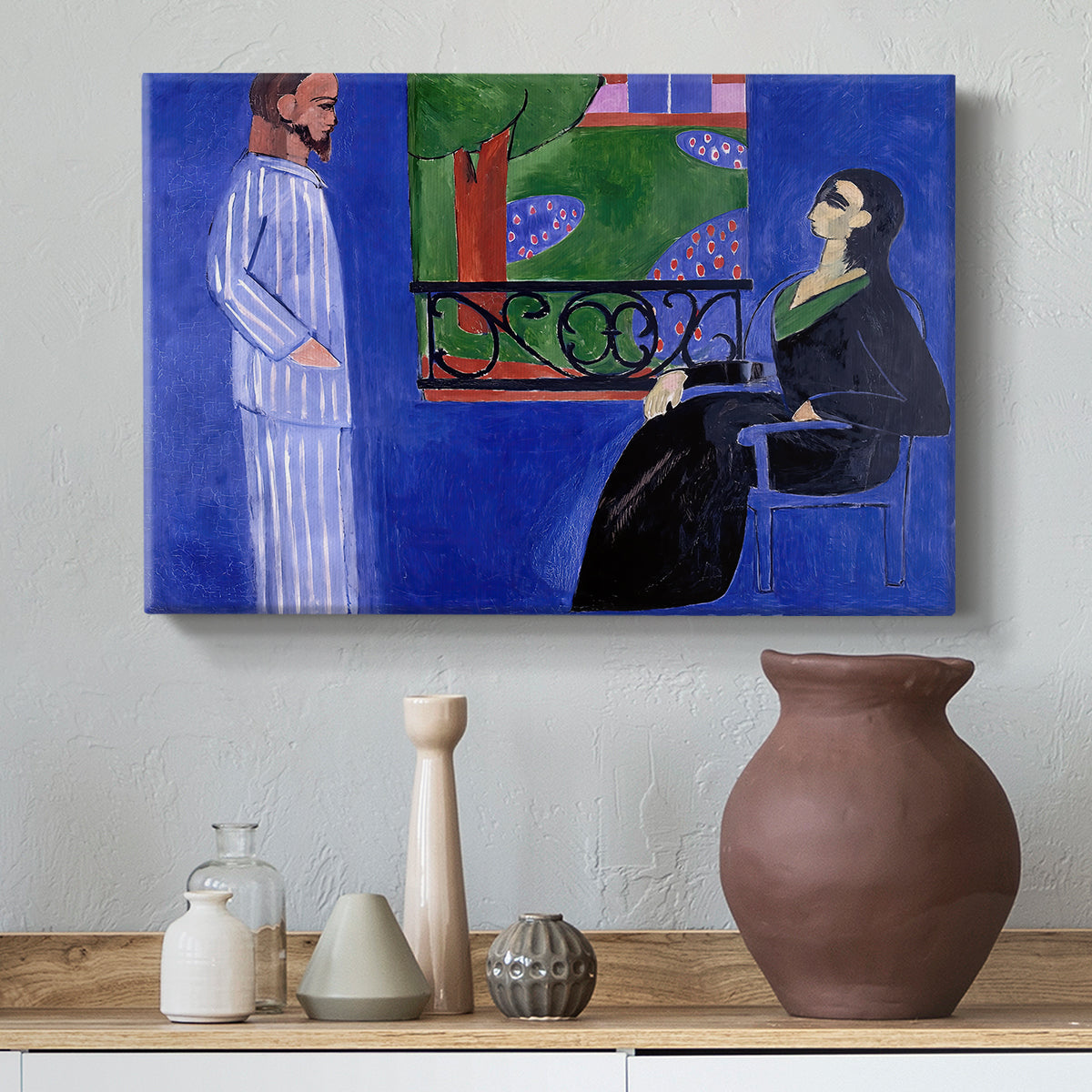 Canvas art print featuring a stylized interior portrait of two people in dialogue, styled above a decorative console