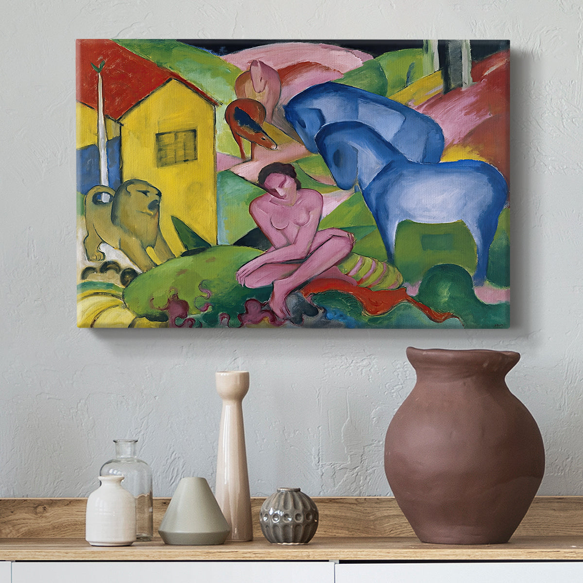 Canvas art print featuring a surreal arrangement of figures and animals in bright palette, styled above a decorative console