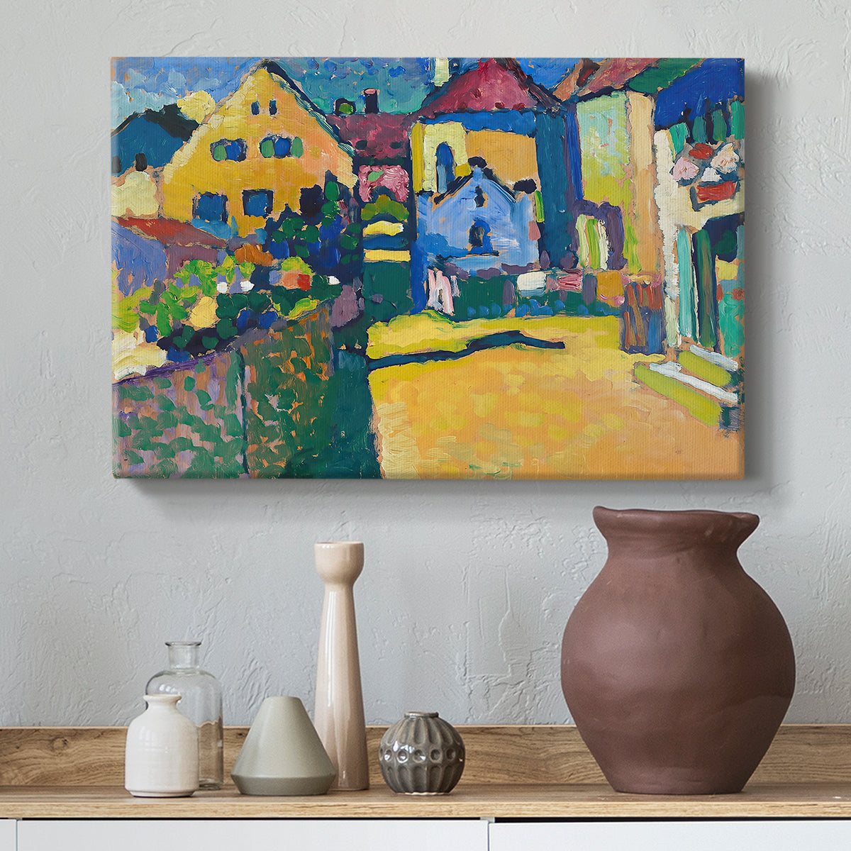 Canvas art print featuring a simplified town scene with bold blocks of color and defined outlines, styled above a decorative console