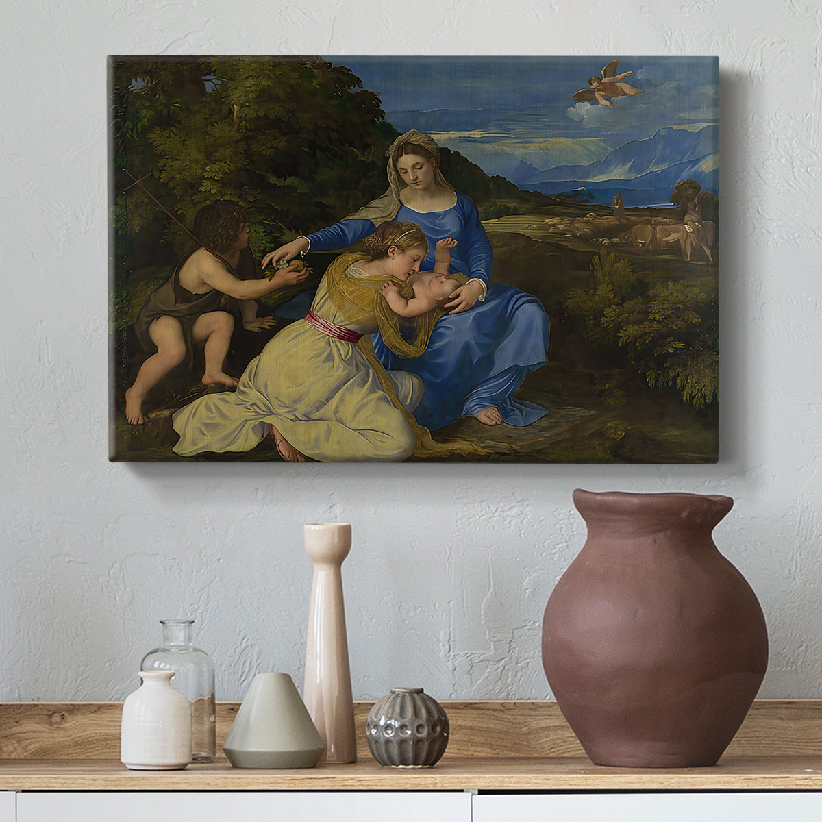 Canvas art print featuring a Renaissance religious composition with seated figures in natural setting, styled above a decorative console