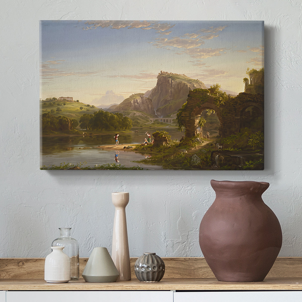 Canvas art print featuring a landscape combining architecture, figures, and open terrain, styled above a decorative console