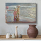 Canvas art print featuring an impressionist scene with women and ocean backdrop, styled above a decorative console