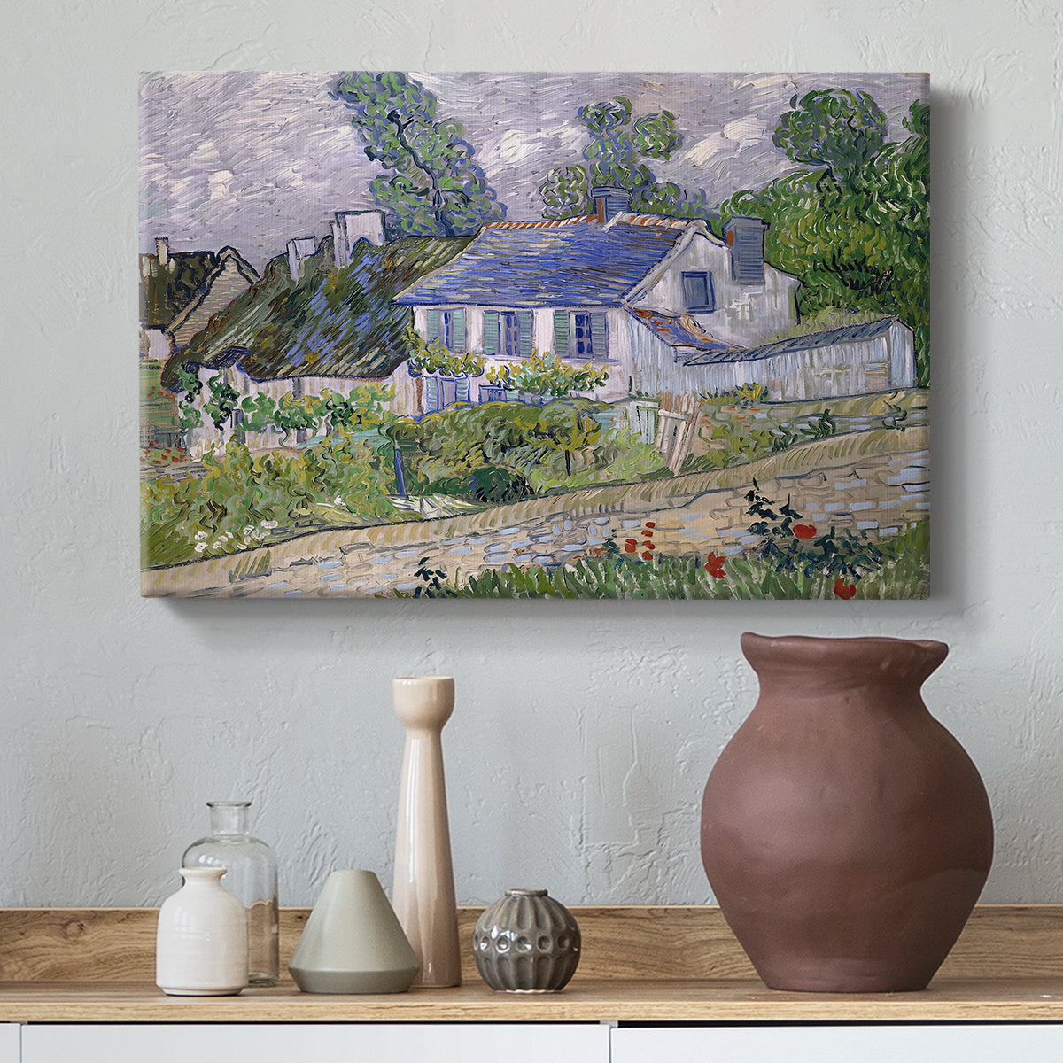 Canvas art print featuring a post-impressionist cityscape with rooftops and vegetation, styled above a decorative console