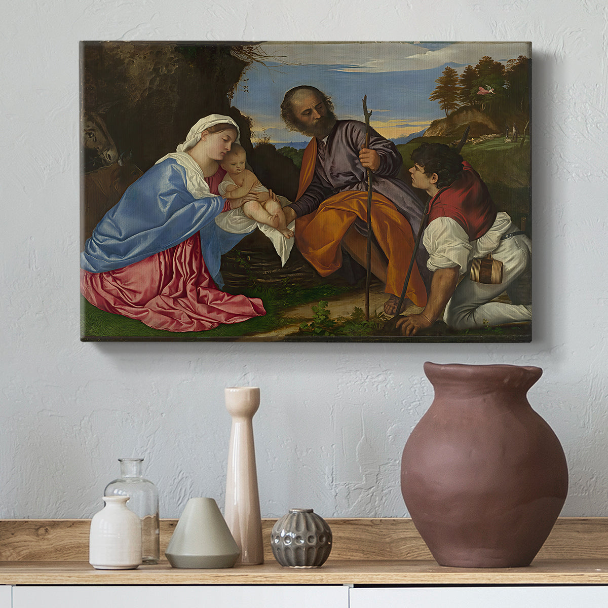 Canvas art print featuring a devotional composition combining sacred family and shepherd figure, styled above a decorative console