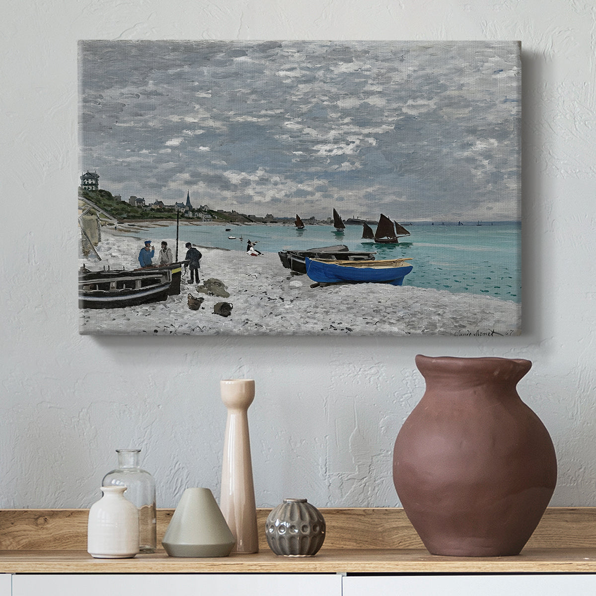 Canvas art print featuring a coastal landscape with sailboats and visitors on cliffside, styled above a decorative console