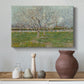 Canvas art print featuring an orchard composition with pale blossoms against open sky, styled above a decorative console