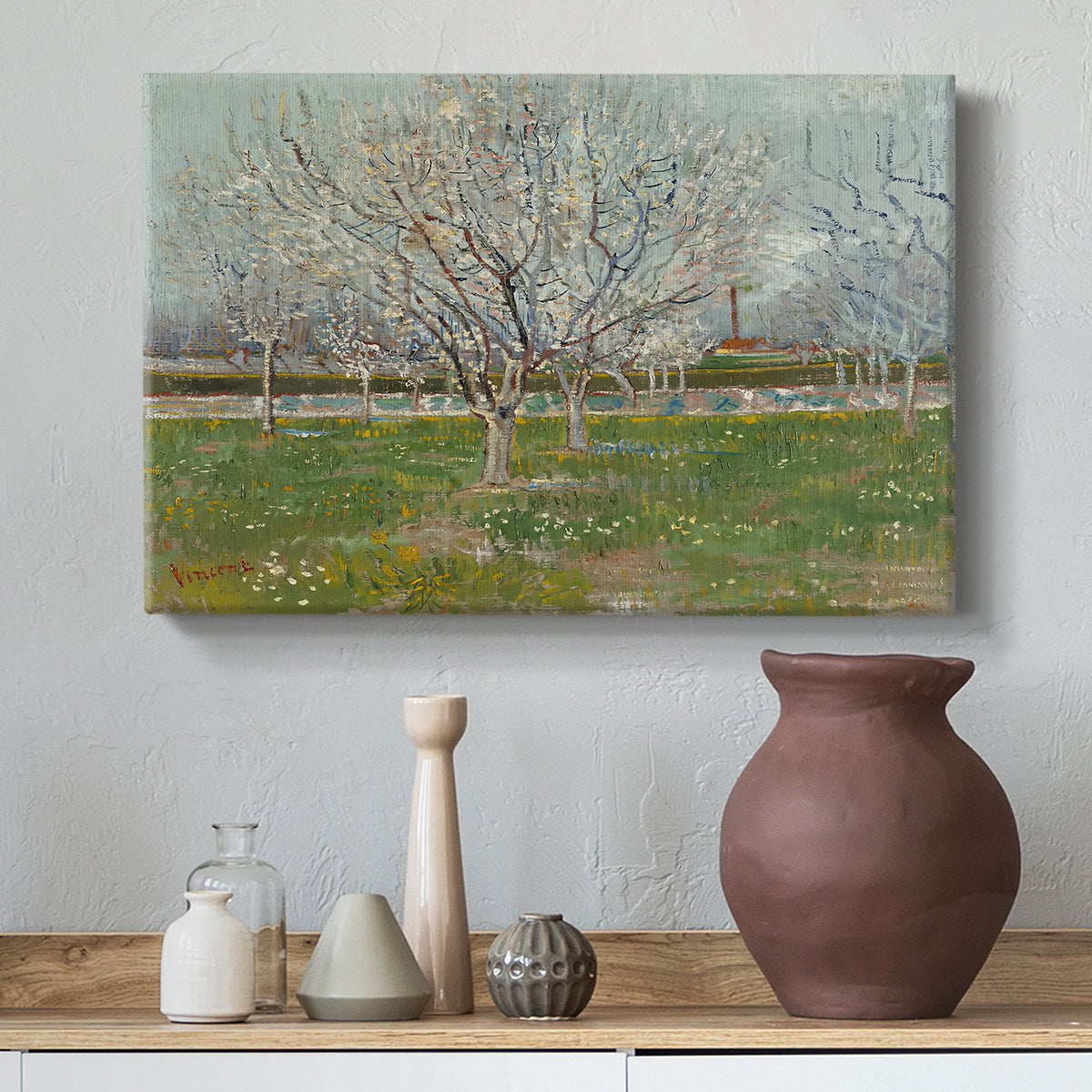 Canvas art print featuring an orchard composition with pale blossoms against open sky, styled above a decorative console