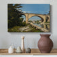 Canvas art print featuring a scenic view of bridge with water and surrounding environment, styled above a decorative console