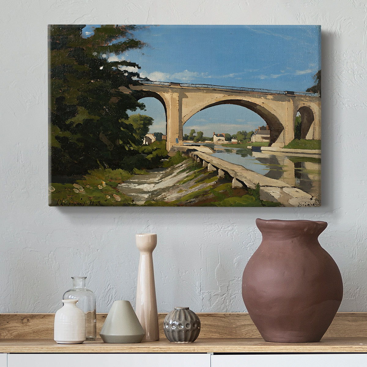 Canvas art print featuring a scenic view of bridge with water and surrounding environment, styled above a decorative console