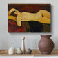 Canvas art print featuring a stylized female nude resting on fabric with warm tones, styled above a decorative console