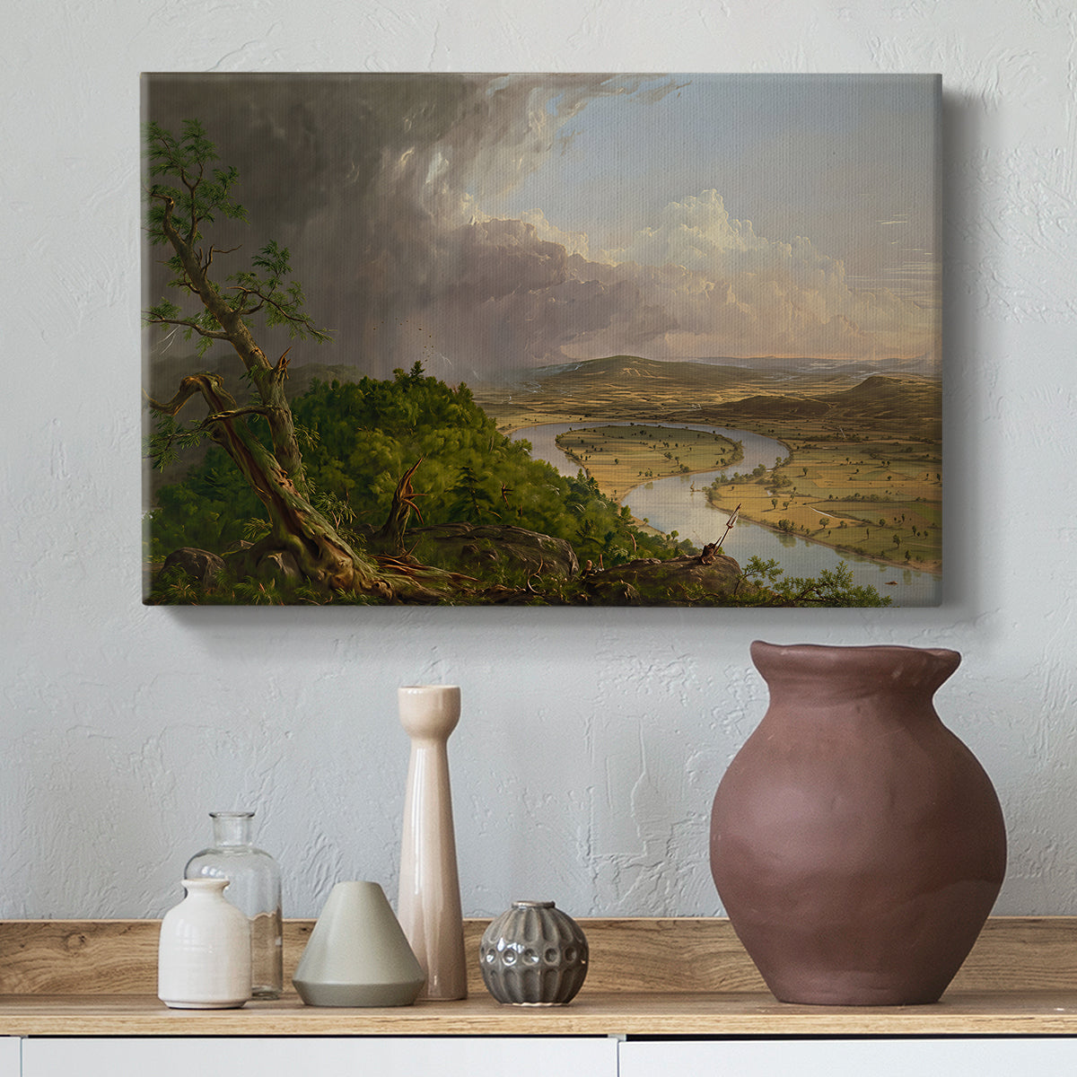Canvas art print featuring a romantic landscape combining wilderness and cultivated land, styled above a decorative console
