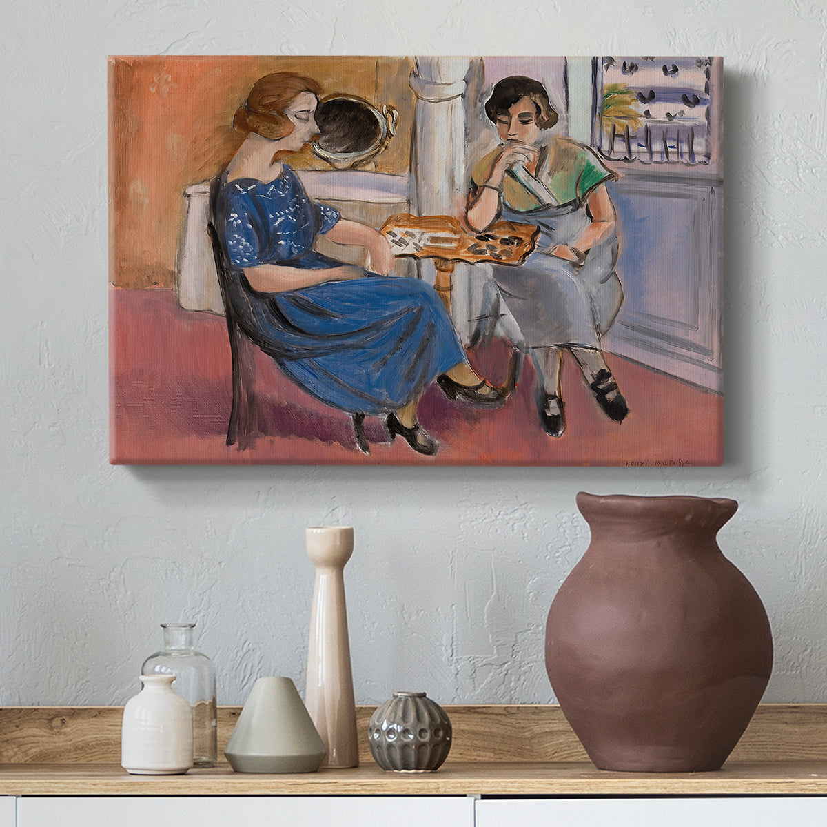 Canvas art print featuring a stylized interior with seated figures playing at a table, styled above a decorative console
