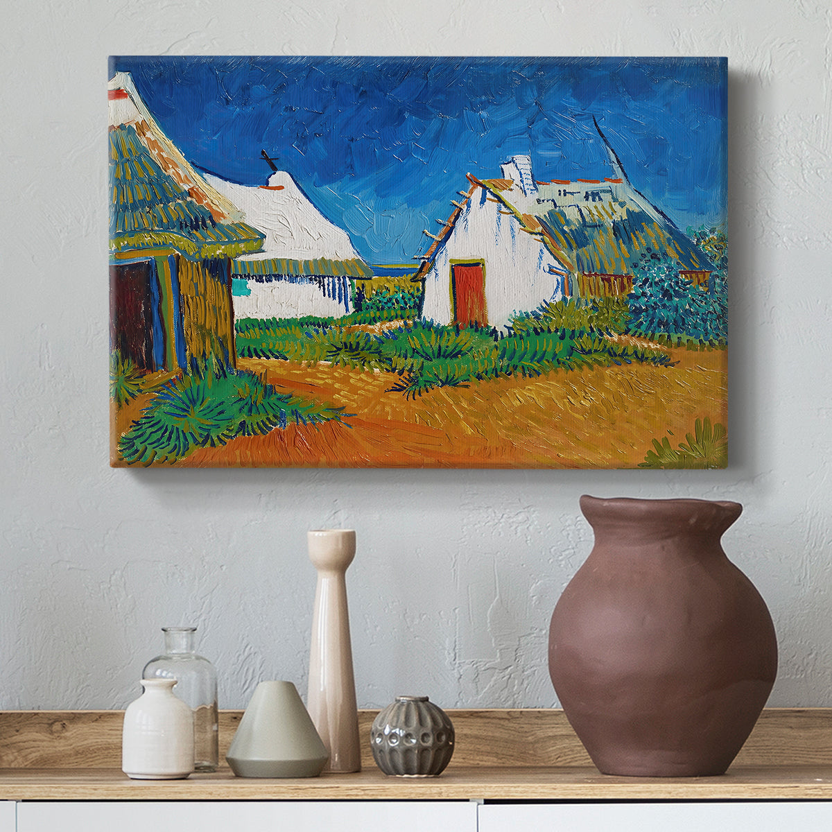 Canvas art print featuring a post-impressionist village composition with strong outlines, styled above a decorative console