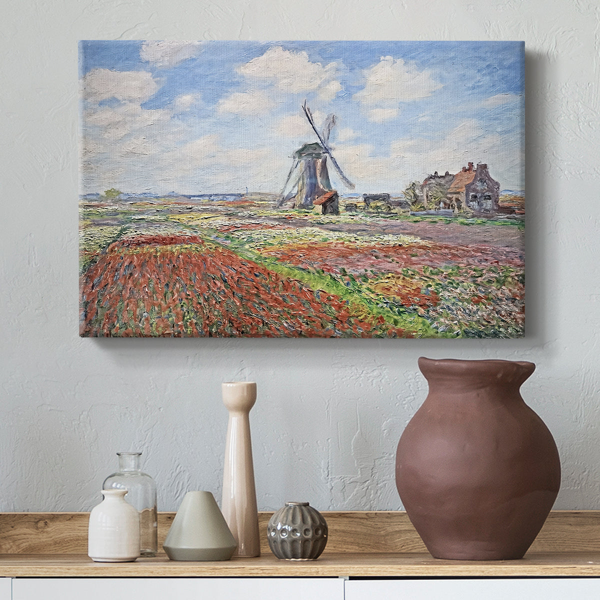 Canvas art print featuring an impressionist field of blooming tulips under bright sky, styled above a decorative console