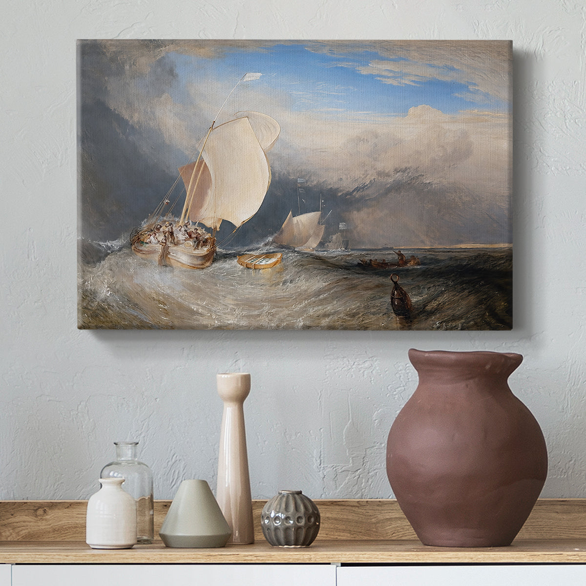 Canvas art print featuring a maritime scene with boats and people gathered along shoreline, styled above a decorative console