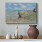 Canvas art print featuring a coastal cliff scene with grass, wind, and expansive sea view, styled above a decorative console